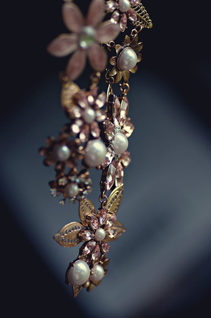 services-03 Close-up of a luxurious floral necklace featuring pearls and gemstones with a vintage charm.